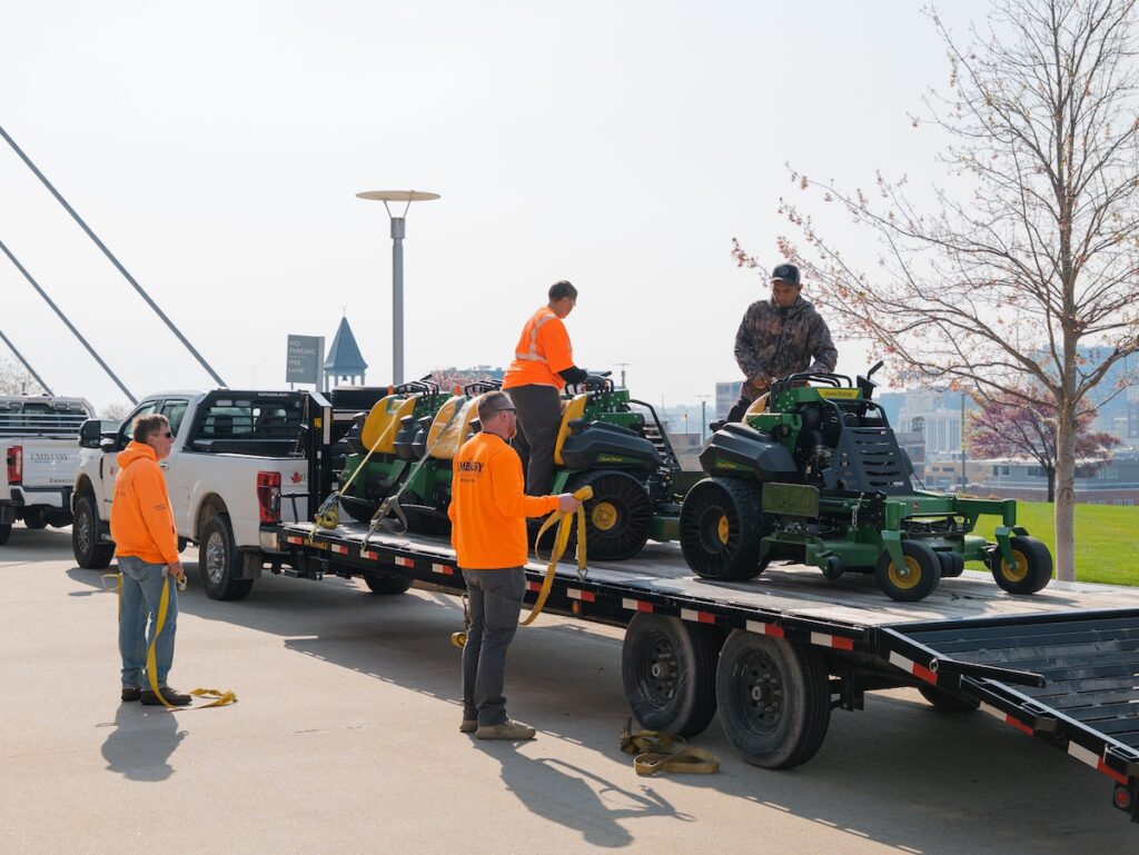 Kansas City's best landscaper unloading mowers at commercial property