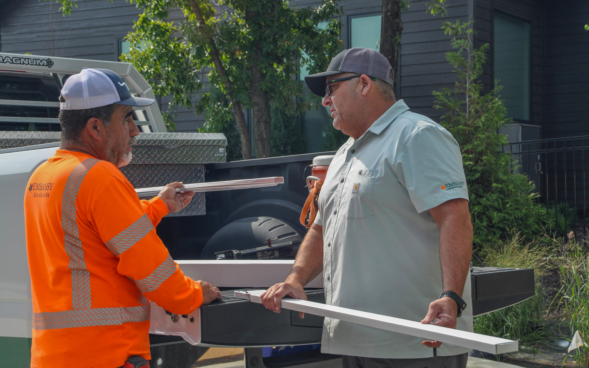 Estate Two Men Conversing On Job Site